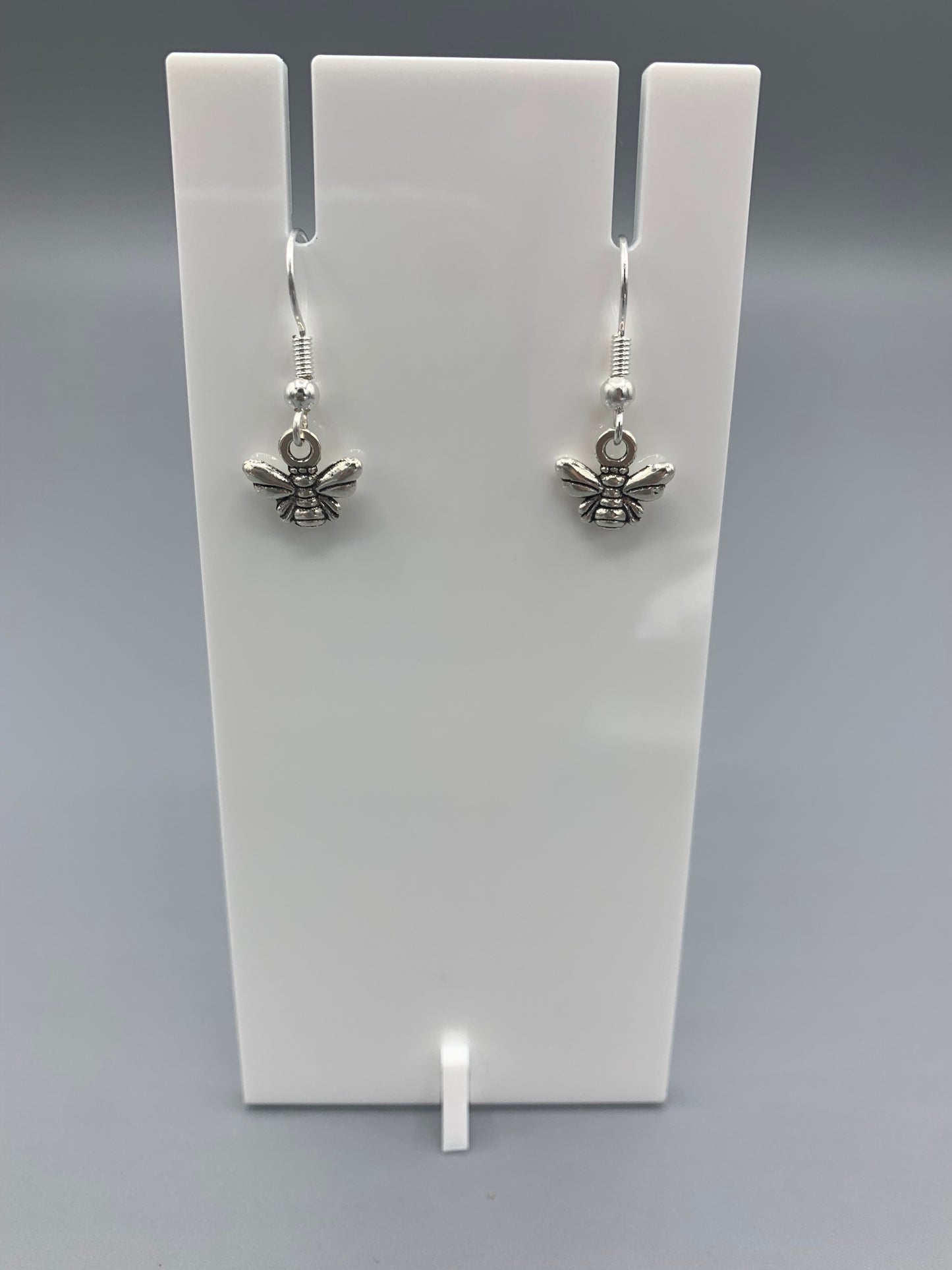 Alloy silver coloured small bee charm on silver plated hooks. Super cute earrings.