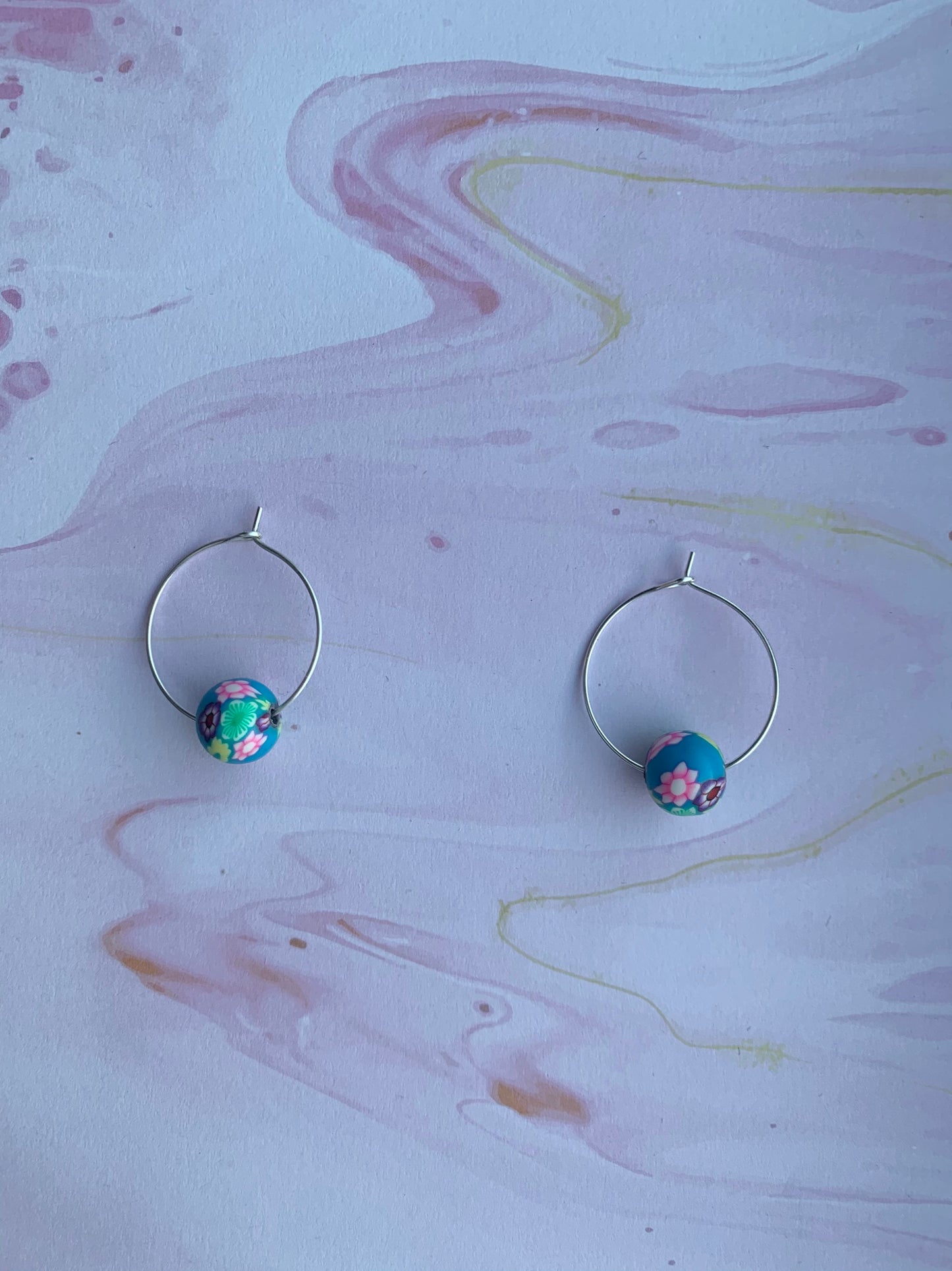 Blue earrings. Polymer clay earrings. flower earrings. Polymer clay flower beads in a variety of colours on silver plated hoops. hoop earrings.