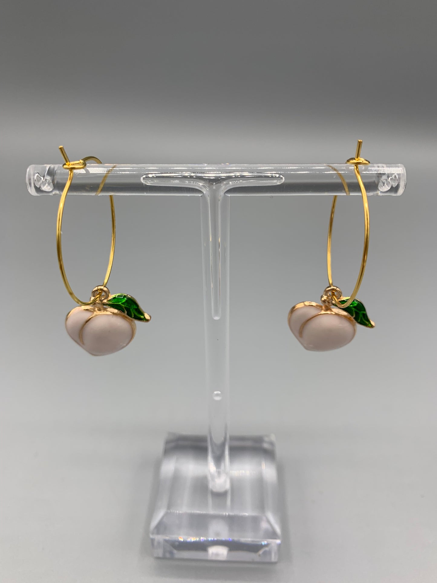 peach earrings. gold earrings. sexy earrings. enamel peach charm on gold plated hoops. hoop earrings. cute earring aesthetic.fun earrings