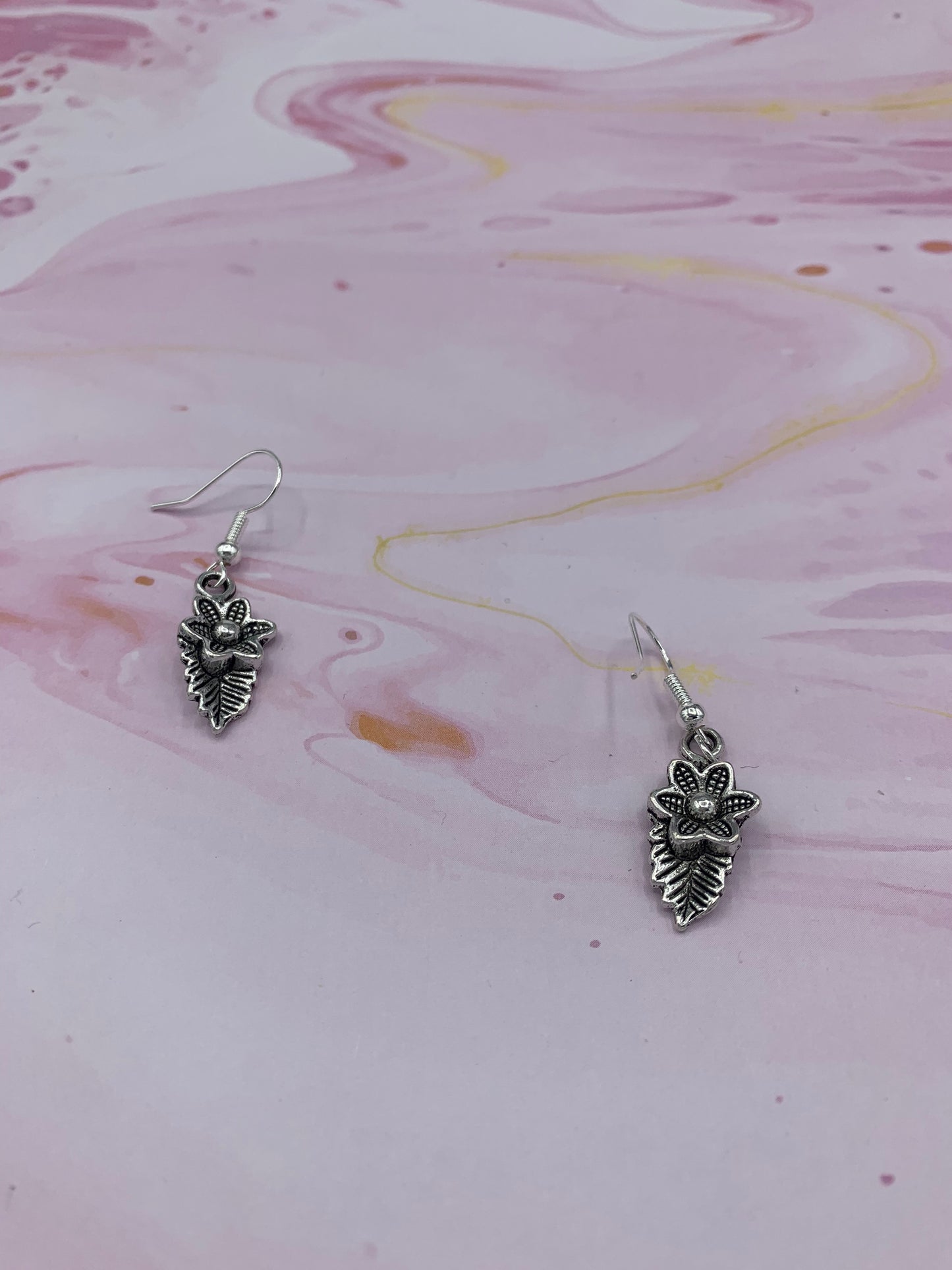Flower earrings. Silver coloured alloy flower with leaf charm on silver plated hooks. Mothers day earrings. Earrings for women. gifts for women.