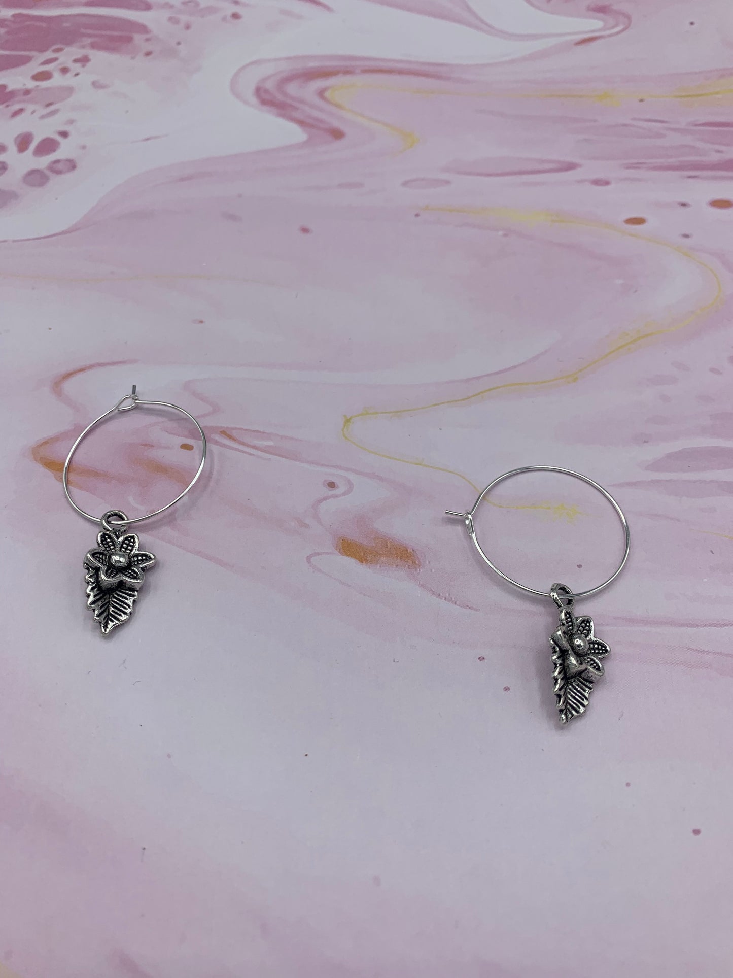 Flower earrings. Silver coloured alloy flower with leaf charm on silver plated hoops. Mothers day earrings. Earrings for women.