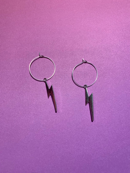 Lightning bolt earrings. Lightning bolt silver coloured alloy charm on silver plated hoops. bestselling earrings. fashion jewellery. funky earrings, hoop earrings. cheap earrings.