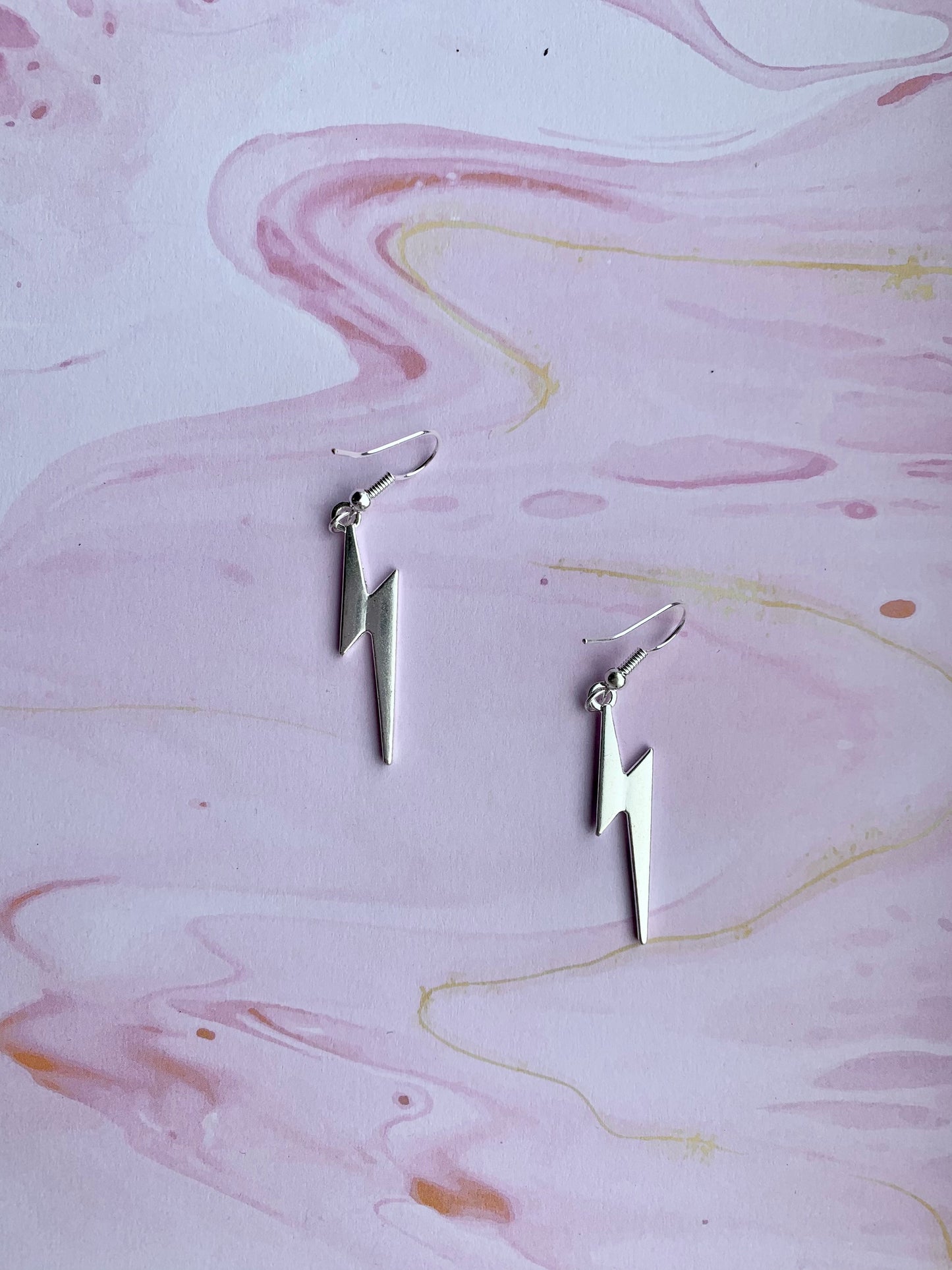 Lightning bolt earrings. Lightning bolt silver coloured alloy charm on silver plated hooks. bestselling earrings. fashion jewllery. funky earrings
