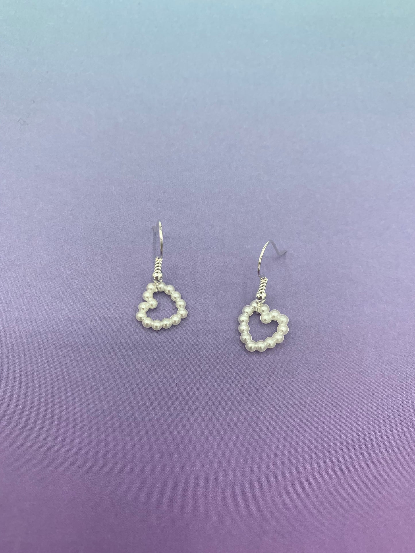 cute earrings. heart earrings. Pearl effect heart charm on silver plated hooks. fashion earrings. cute earrings for girls.