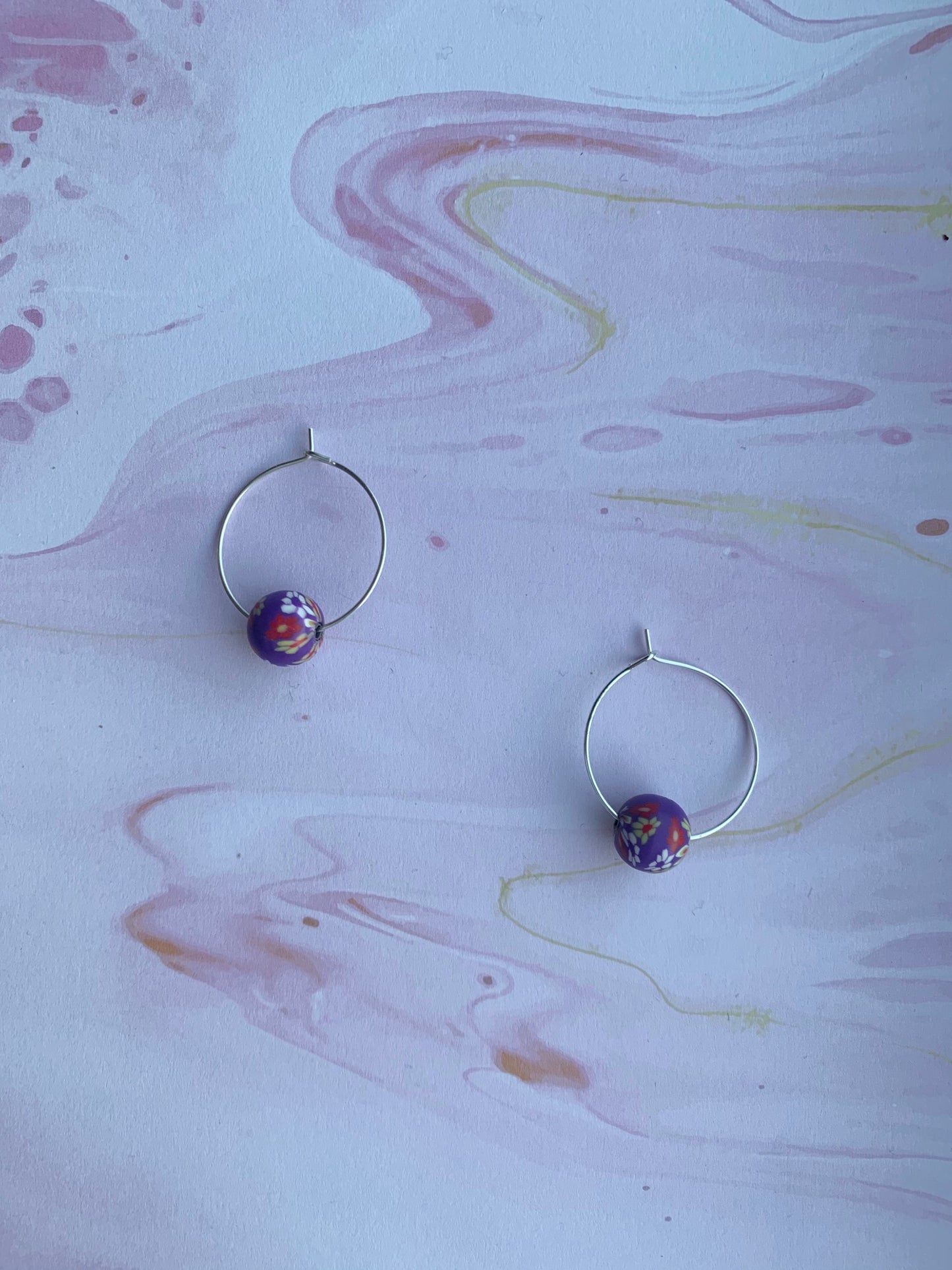 Purple earrings. Polymer clay earrings. flower earrings. Polymer clay flower beads in a variety of colours on silver plated hoops. hoop earrings.