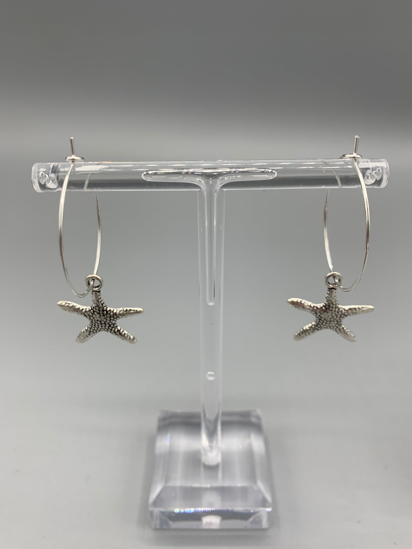 starfish earrings. mermaid earrings. alloy silver coloured charm on silver plated hoops. cute earrings. hoop earrings.