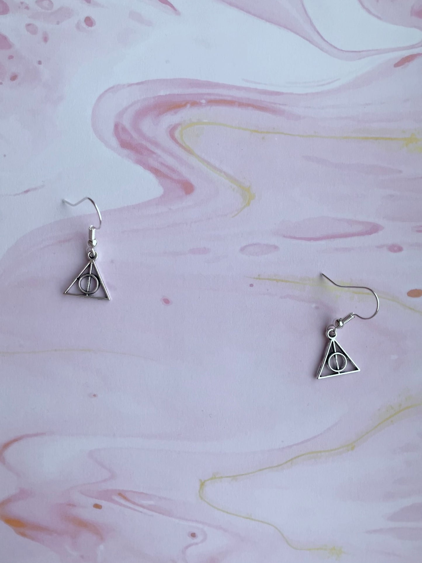 Triangle with circle and stick through the middle charms on silver plated hooks. magical earrings. harry potter earrings. cosplay earrings.