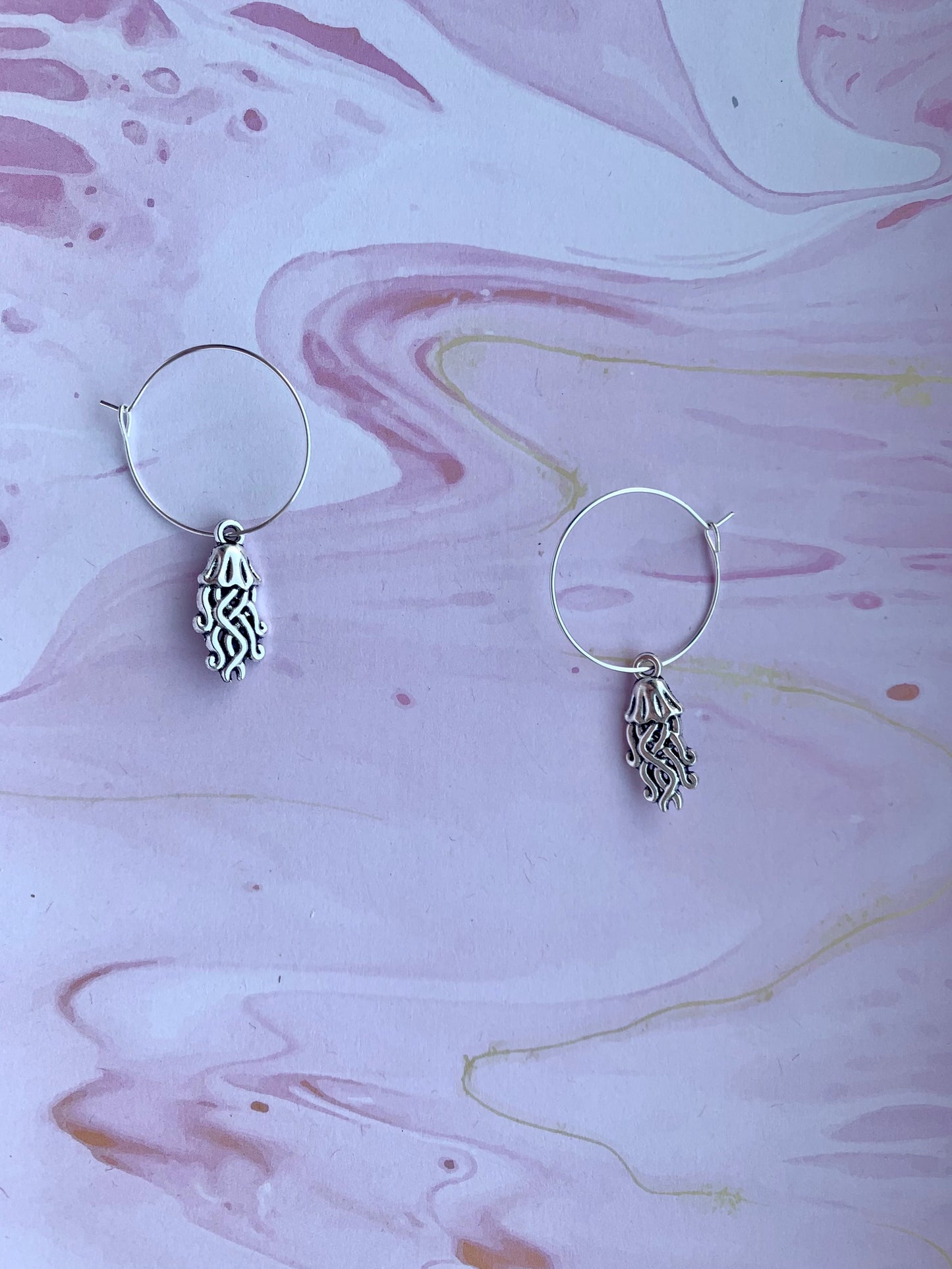 Front view of Jellyfish Earrings featuring a delicate marine design with silver-plated hoops
