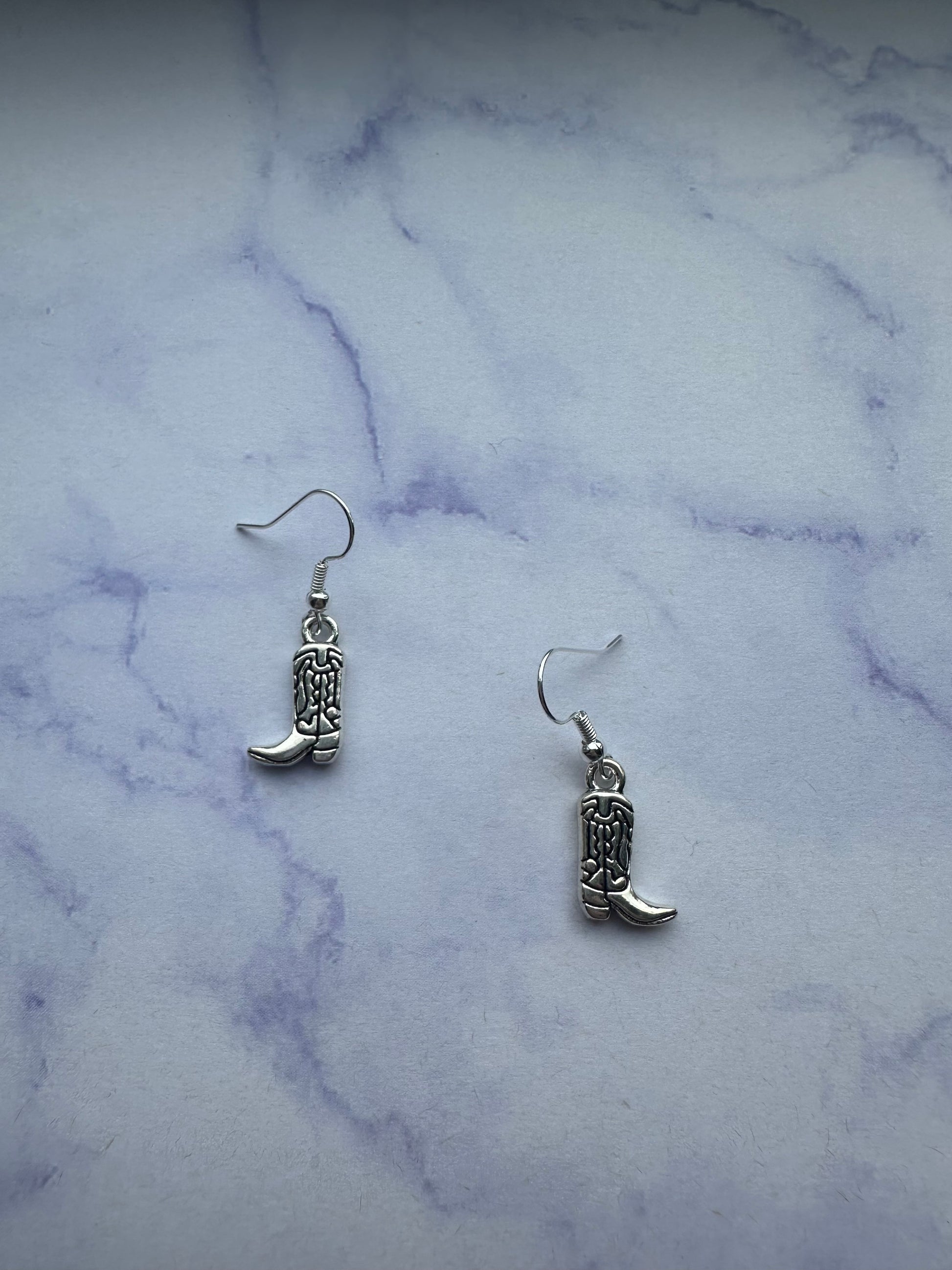 Stylish cowboy boot earrings, perfect for line dancing and country-themed events.