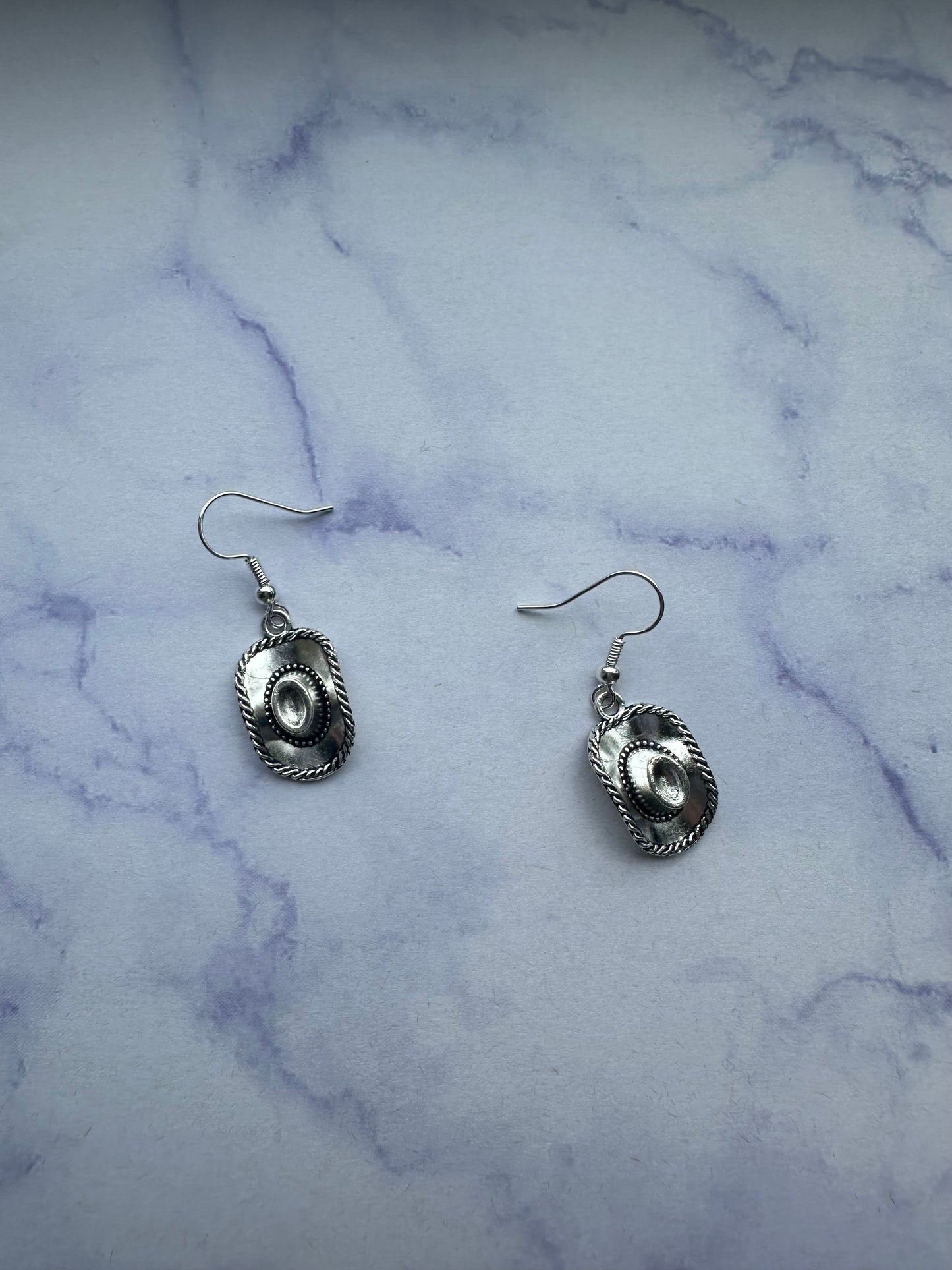 Stylish silver cowboy hat earrings, an ideal choice for country western jewellery fans in the UK. On silver plated hooks. 