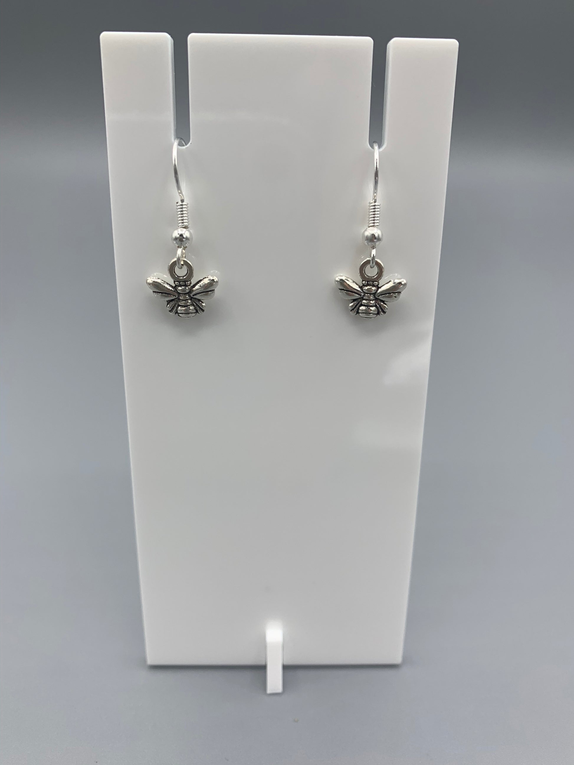 Alloy silver coloured small bee charm on silver plated hooks. Super cute earrings. 