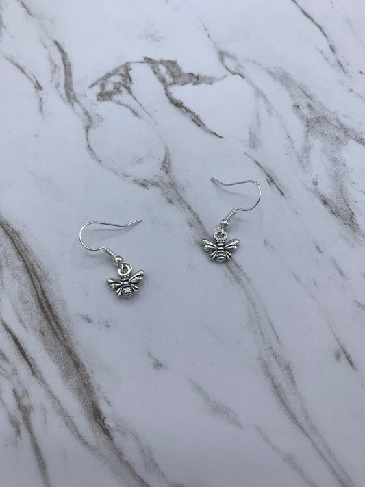 Alloy silver coloured small bee charm on silver plated hooks, a dangle earring. Super cute earrings. 