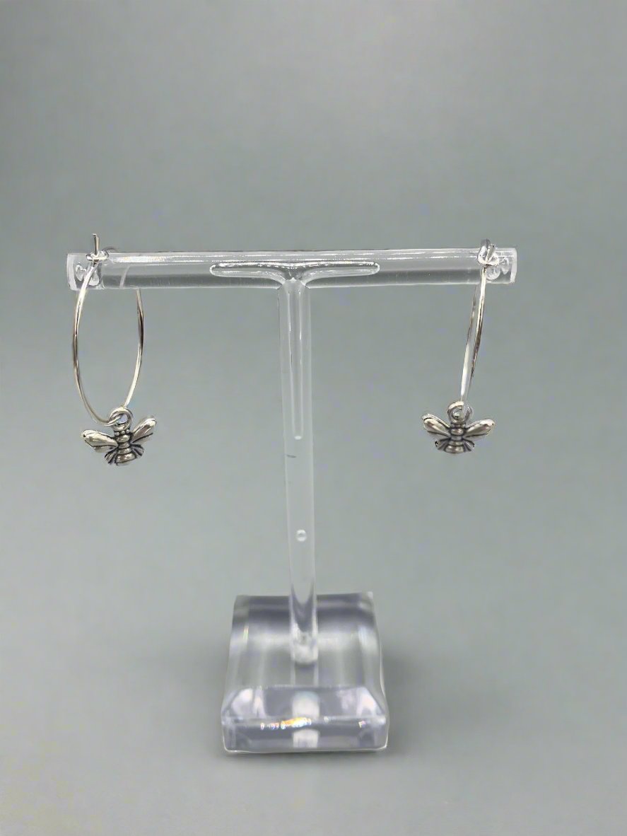 Alloy silver coloured small bee charm on silver plated hoops. Super cute earrings. 