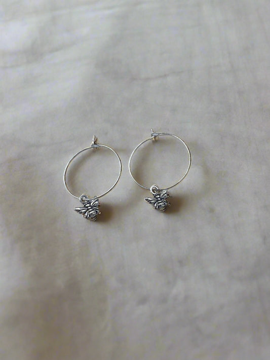 Alloy silver coloured small bee charm on silver plated hoops. Super cute earrings. 
