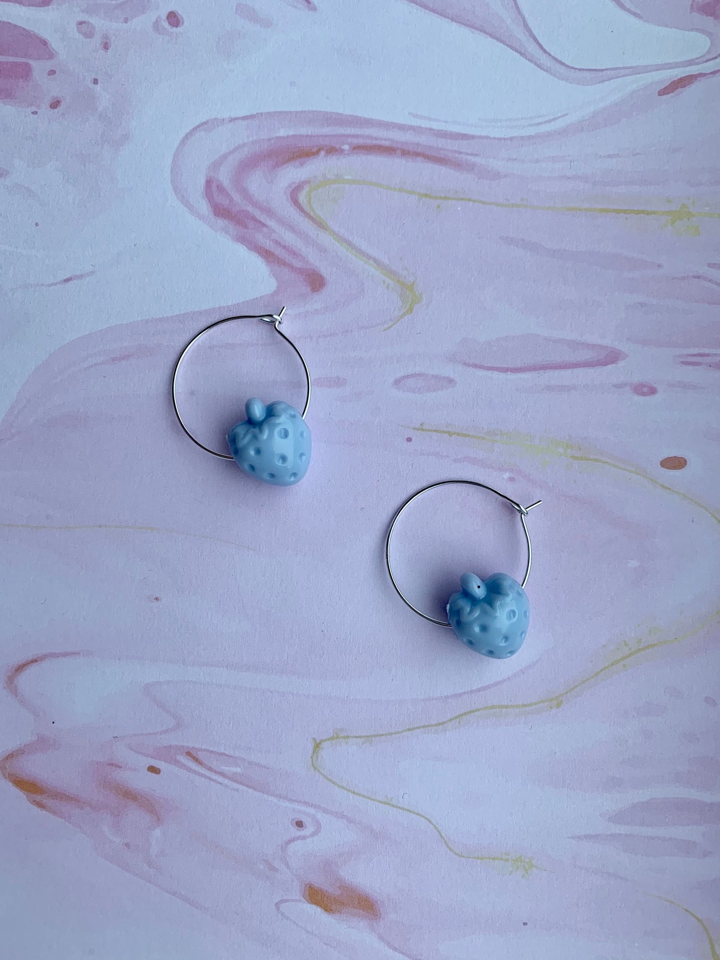 Blue coloured strawberry hoop earrings. fun earrings