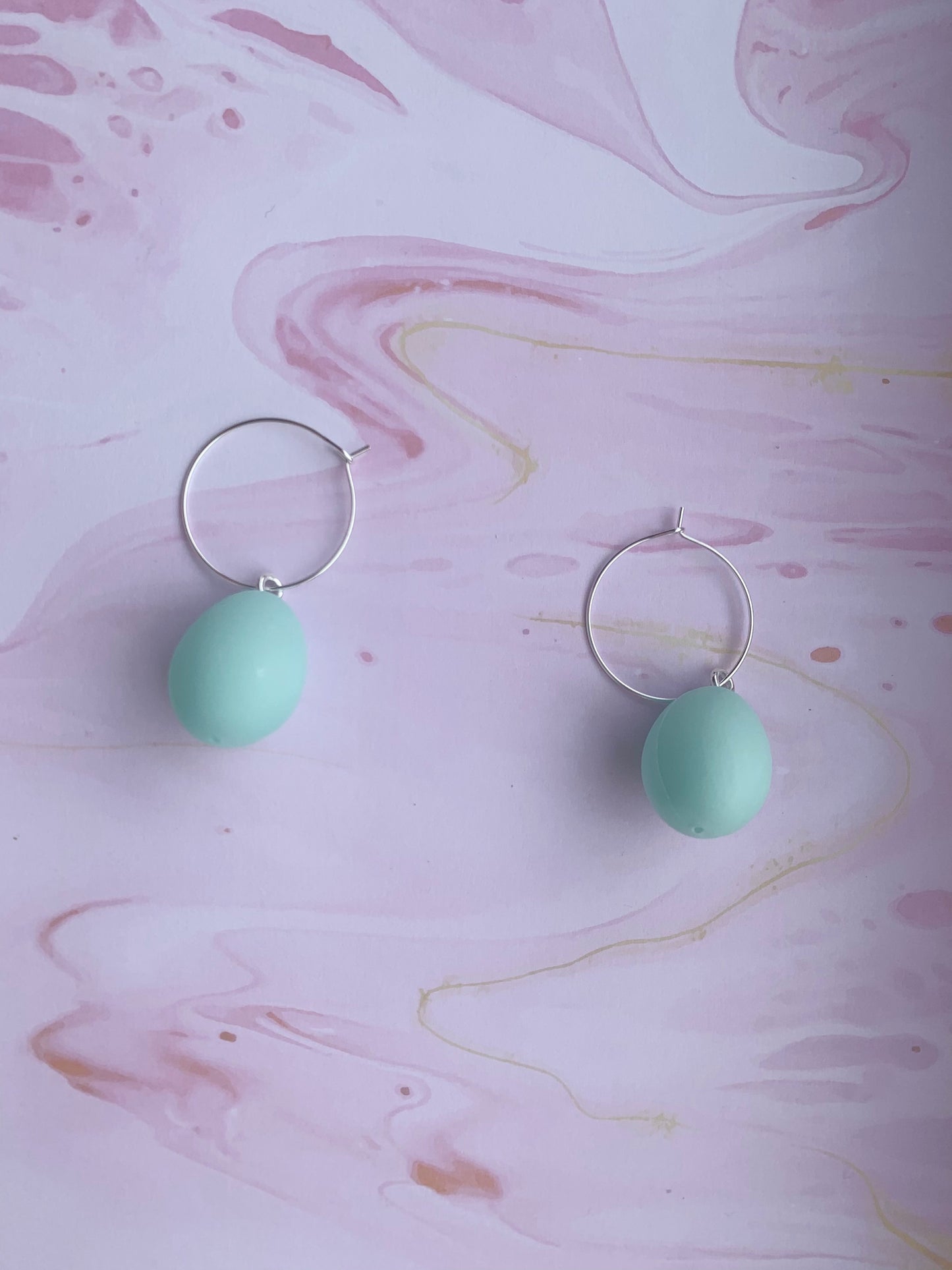 Easter Earrings. Pastel blue easter egg earrings on silver plated hoops. Plastic egg novelty easter earrings in pastel or speckled colours. Hoop earrings. Novelty earrings. pastel earrings. hoop earrings.