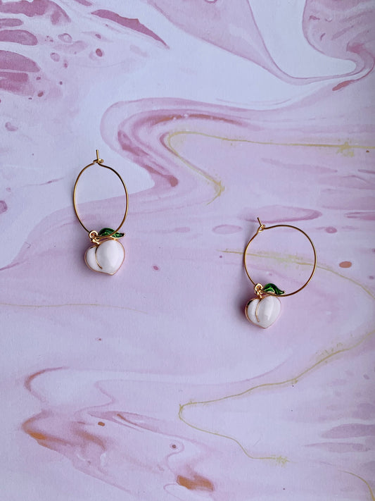 peach earrings. gold earrings. sexy earrings. enamel peach charm on gold plated hoops. hoop earrings. cute earring aesthetic.