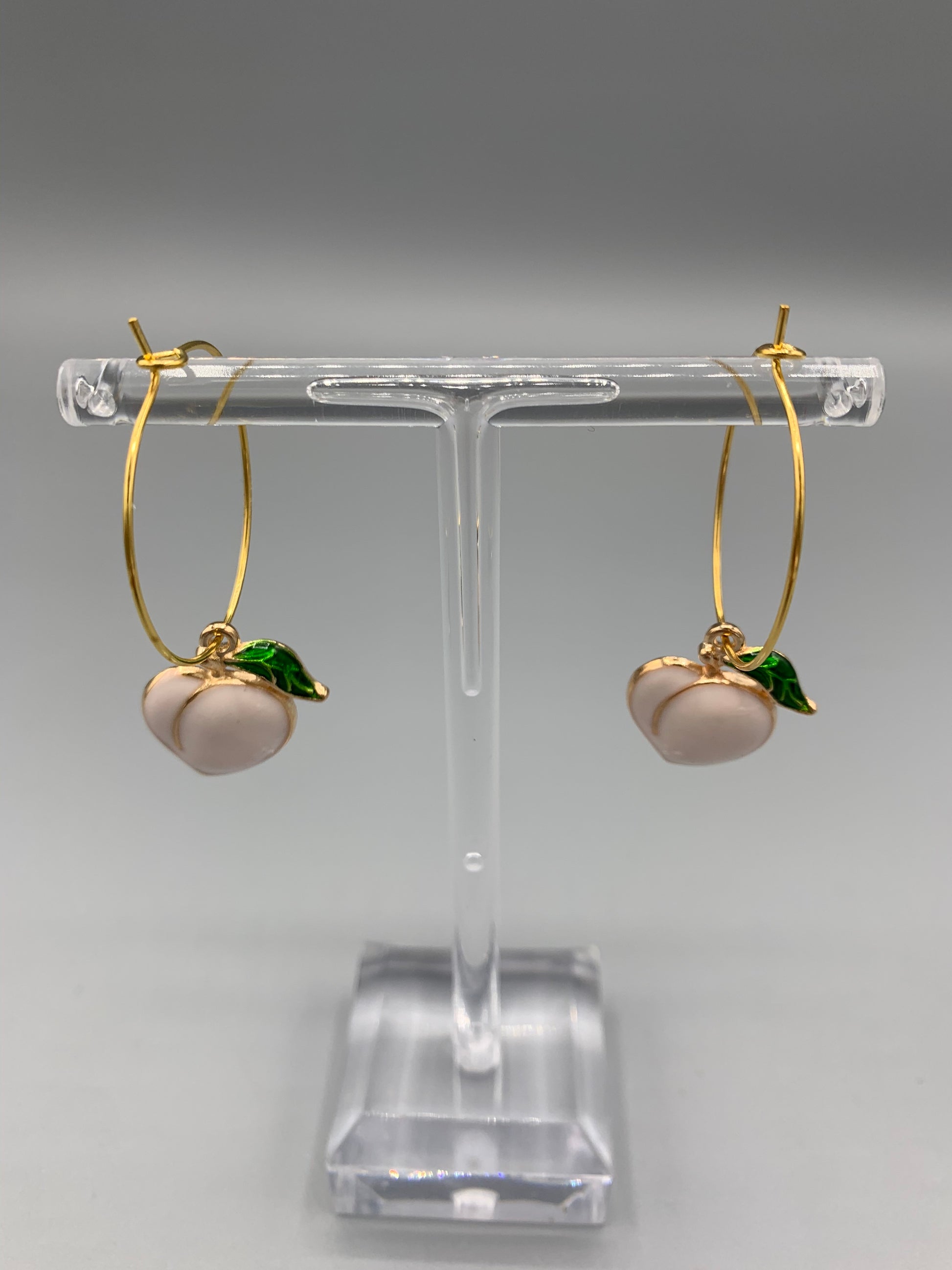 peach earrings. gold earrings. sexy earrings. enamel peach charm on gold plated hoops. hoop earrings. cute earring aesthetic.fun earrings