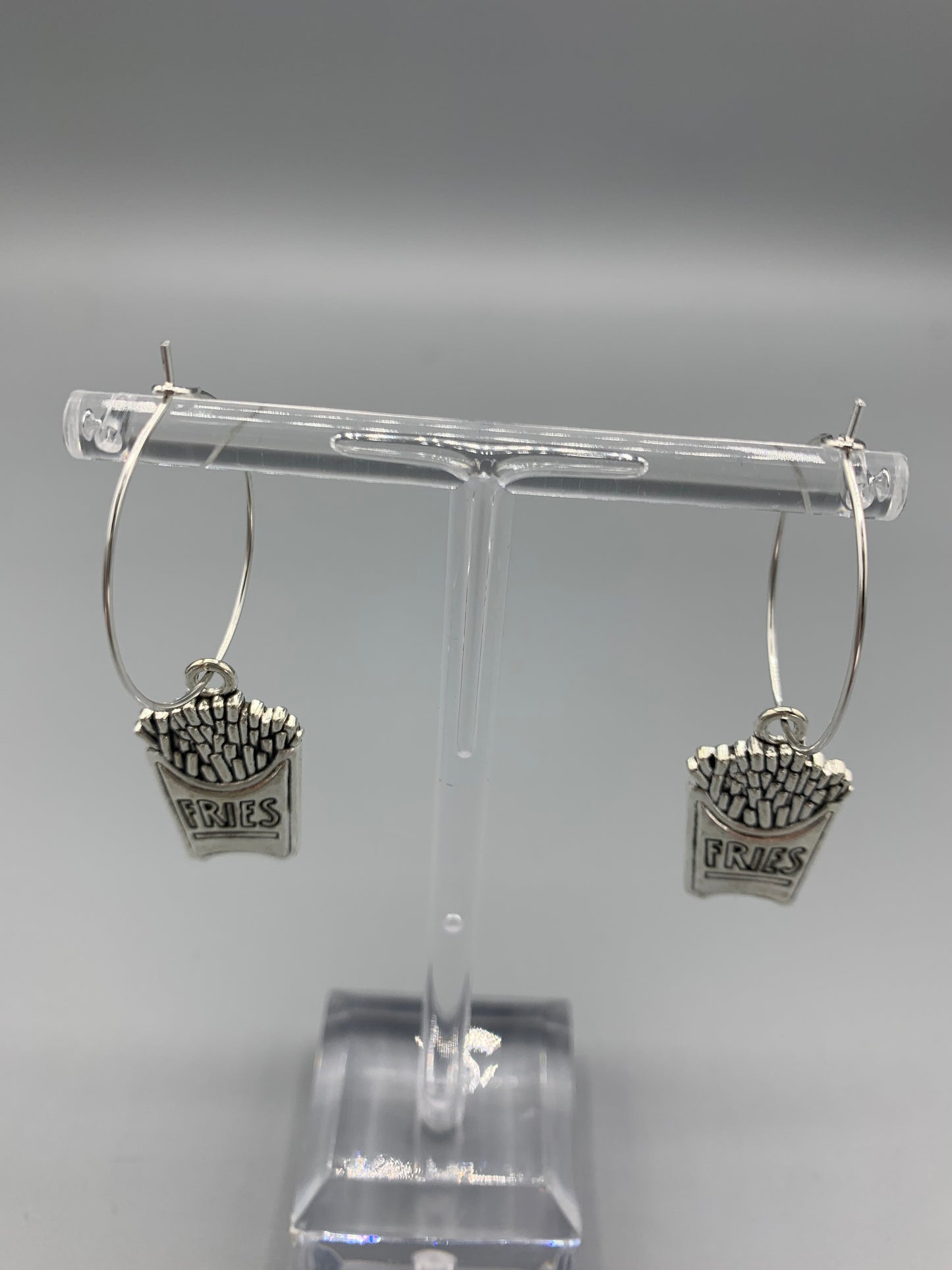 Fries earrings. food earrings. novelty earrings. fun earrings. Silver coloured alloy fries charm on silver plated hoops. hoop earrings. 