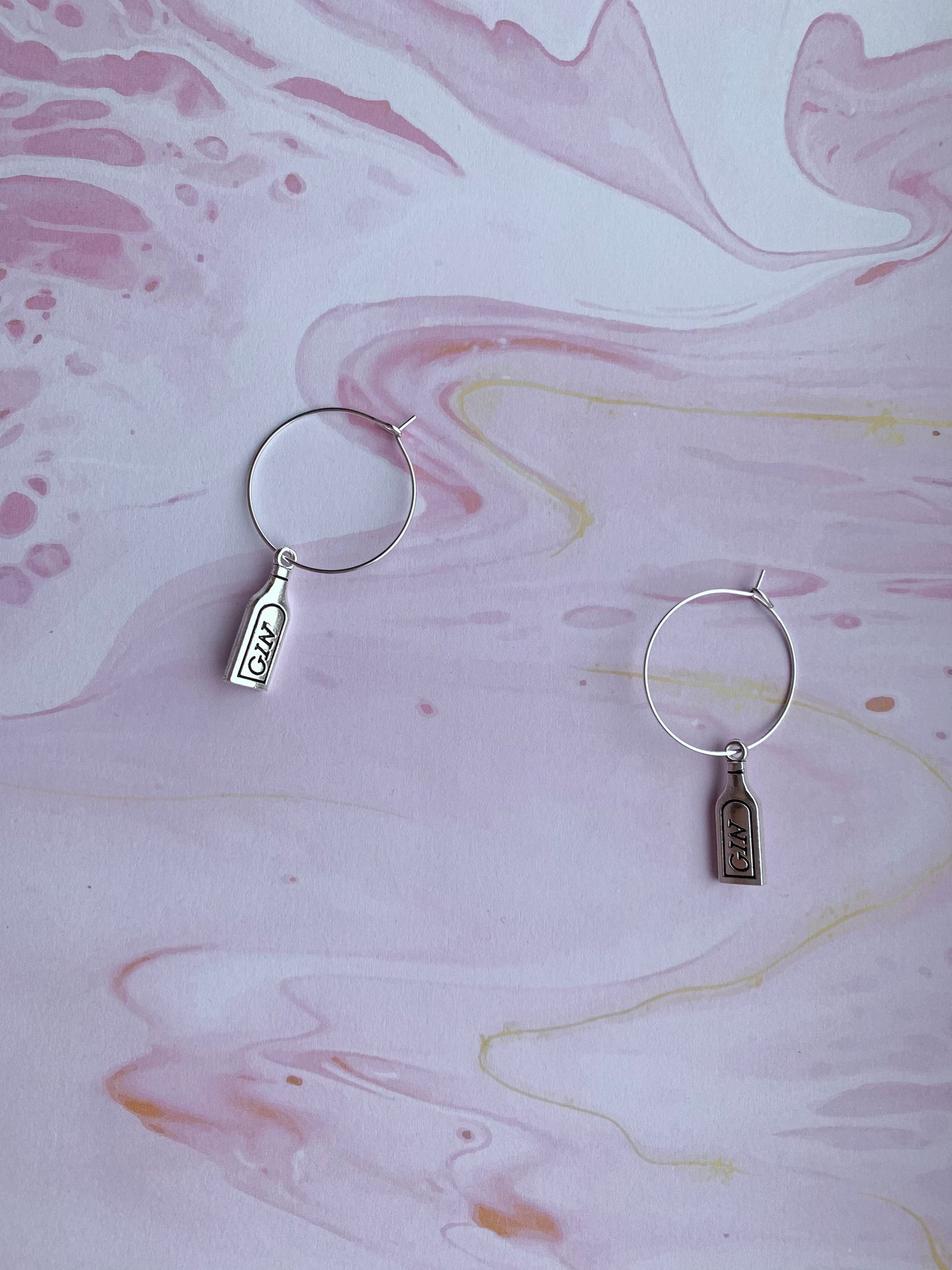 Fun gin earrings shaped like bottles, great for gin tasting events or unique birthday gifts. On Hoops. 