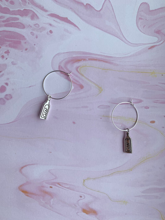 Fun gin earrings shaped like bottles, great for gin tasting events or unique birthday gifts. On Hoops. 