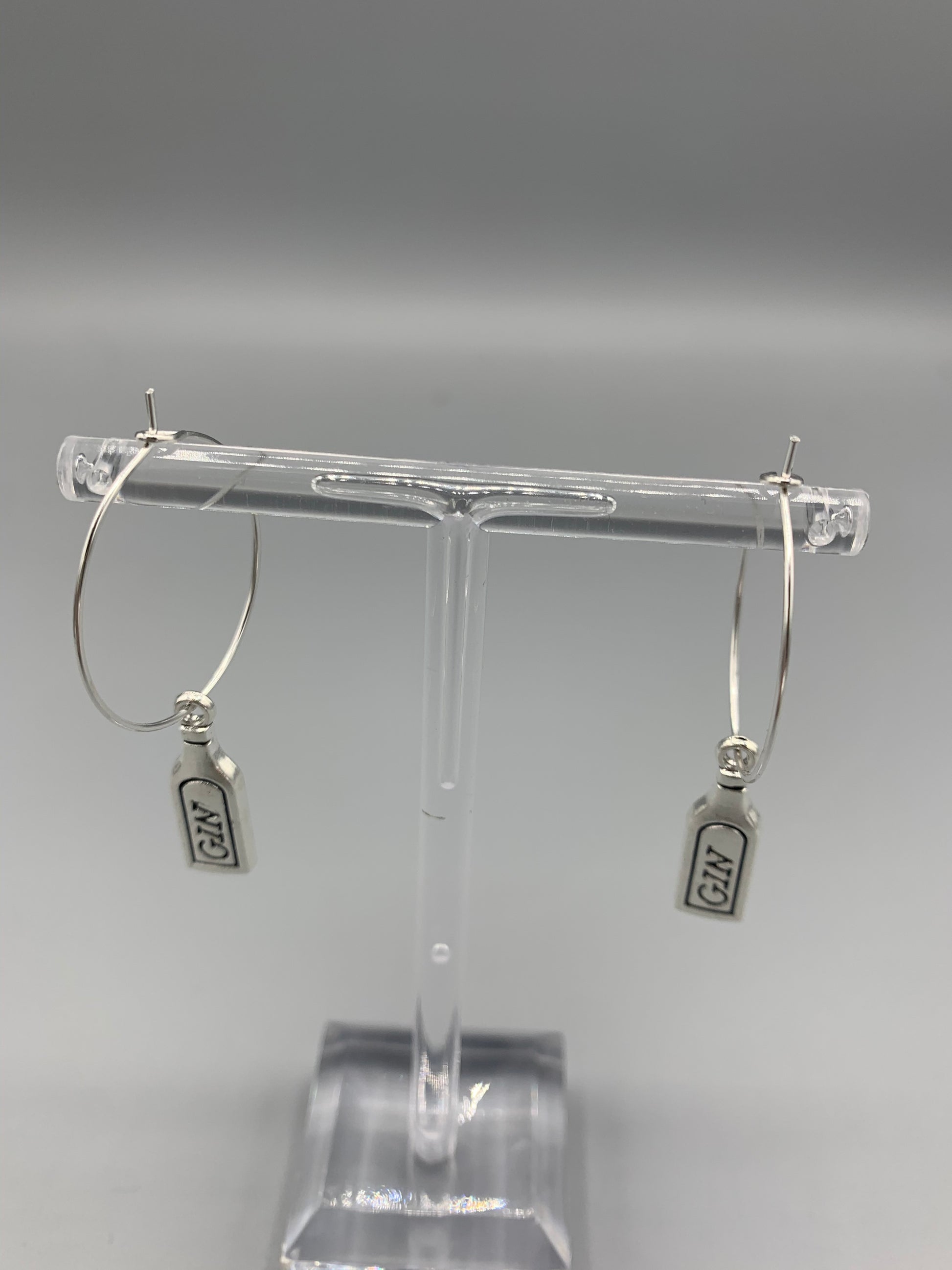 Gin bottle earrings. Alloy metal silver coloured gin bottle charm on silver plated hoops. metal earrings. fun earrings. 