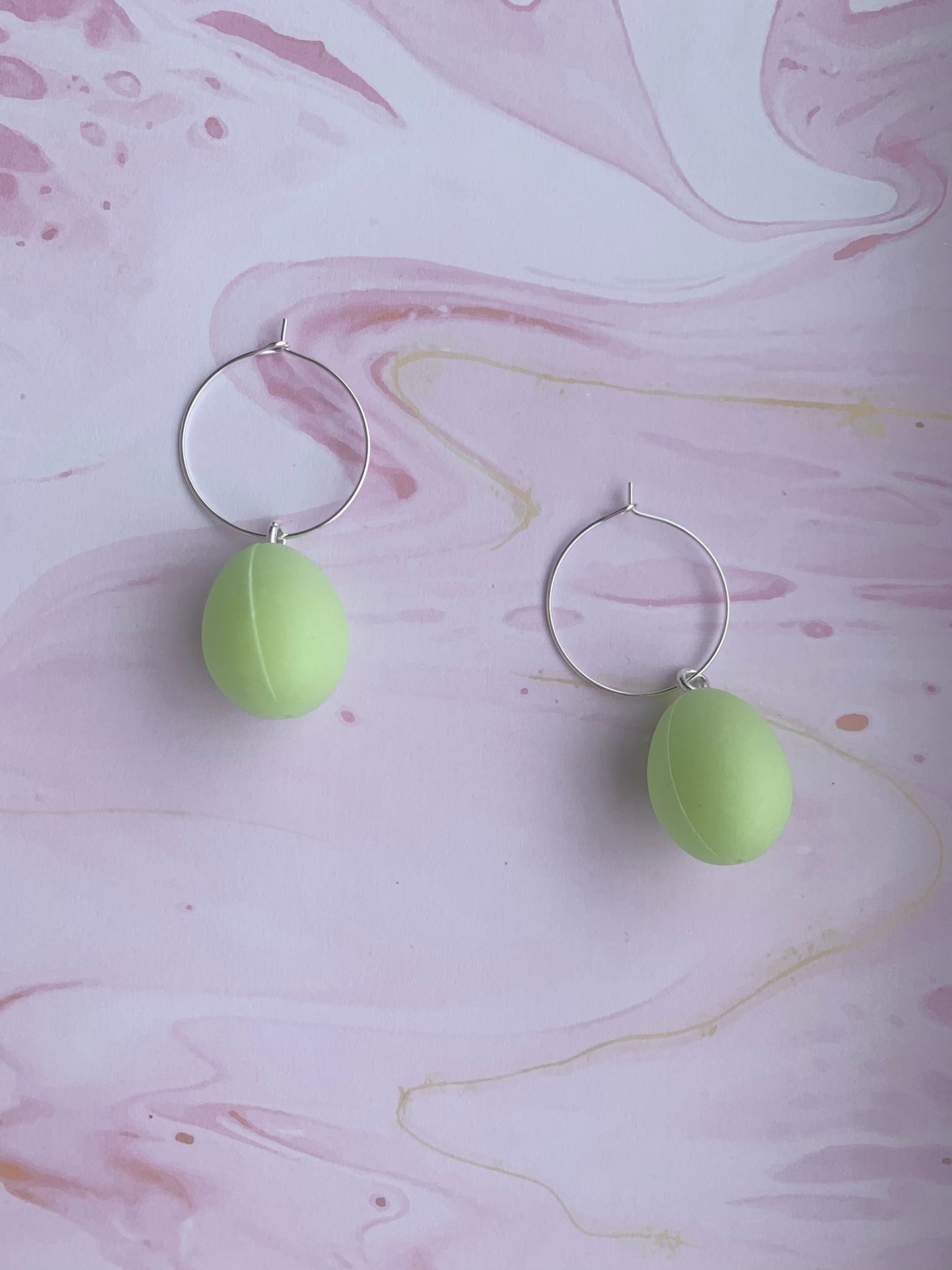 Easter Earrings. Pastel green easter egg earrings on silver plated hoops. Plastic egg novelty easter earrings in pastel or speckled colours. Hoop earrings. Novelty earrings. pastel earrings. hoop earrings. 