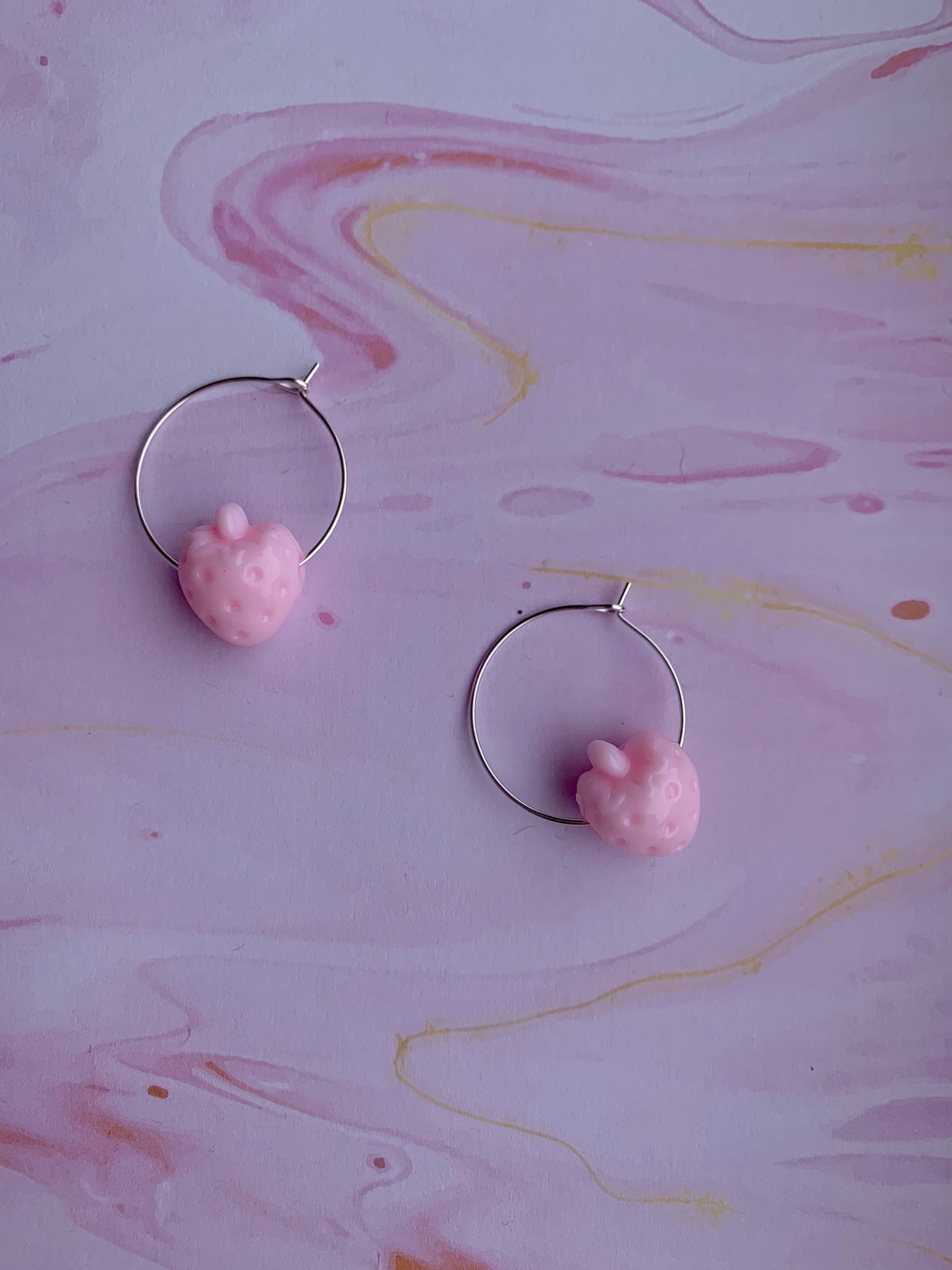 Light pink coloured strawberry hoop earrings. cute earrings