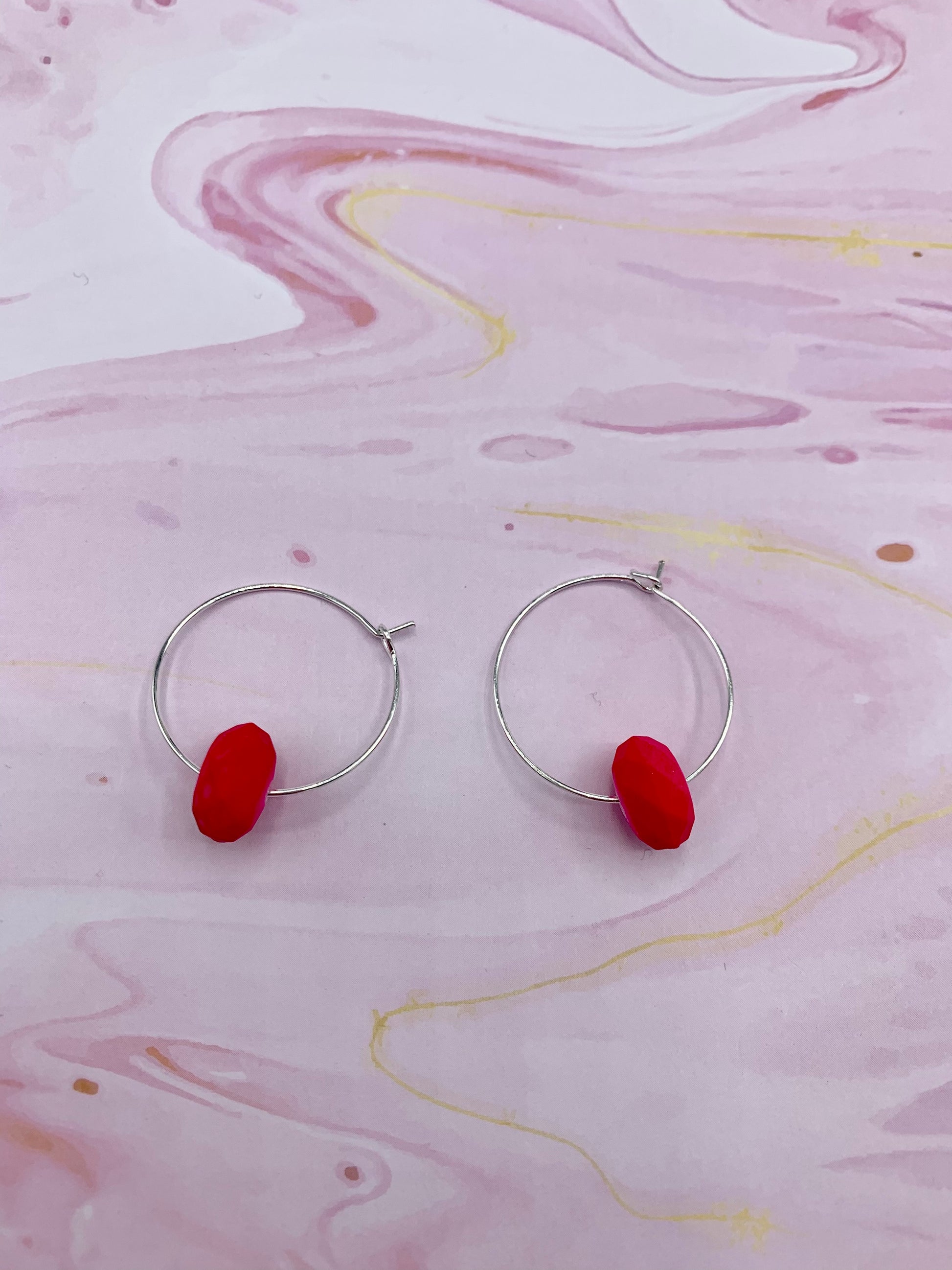 pink earrings. neon earrings. Neon pink faceted bead on silver plated hoops. hoop earrings. 