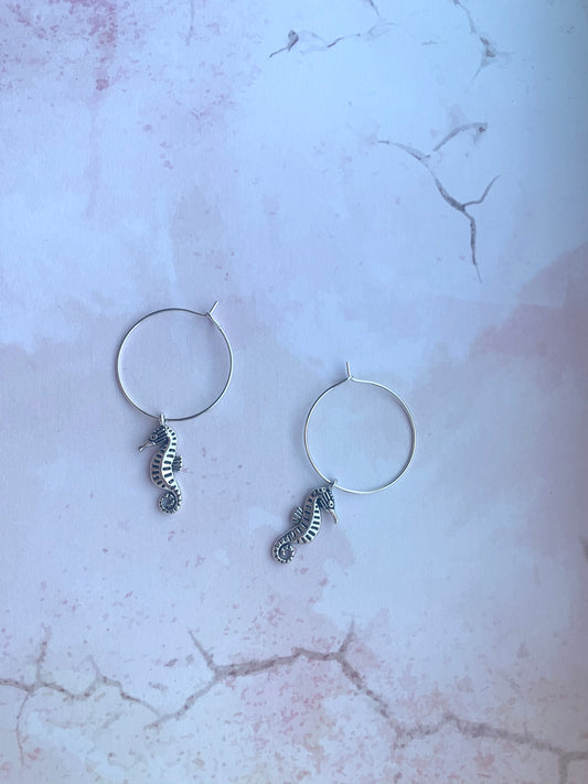 seahorse earrings. holiday earrings. Silver coloured alloy seahorse charm on silver plated hoops. hoop earrings. animal earrings. 