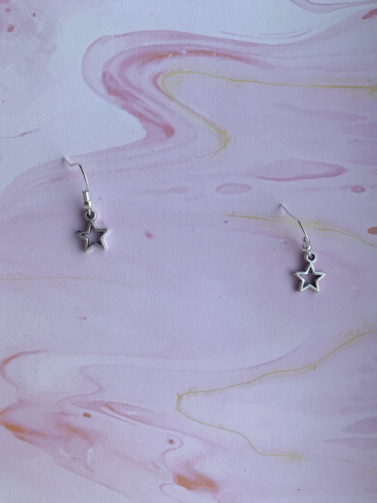Star earrings. alloy silver coloured star hollow outline charm on silver plated hooks. pretty earrings. 