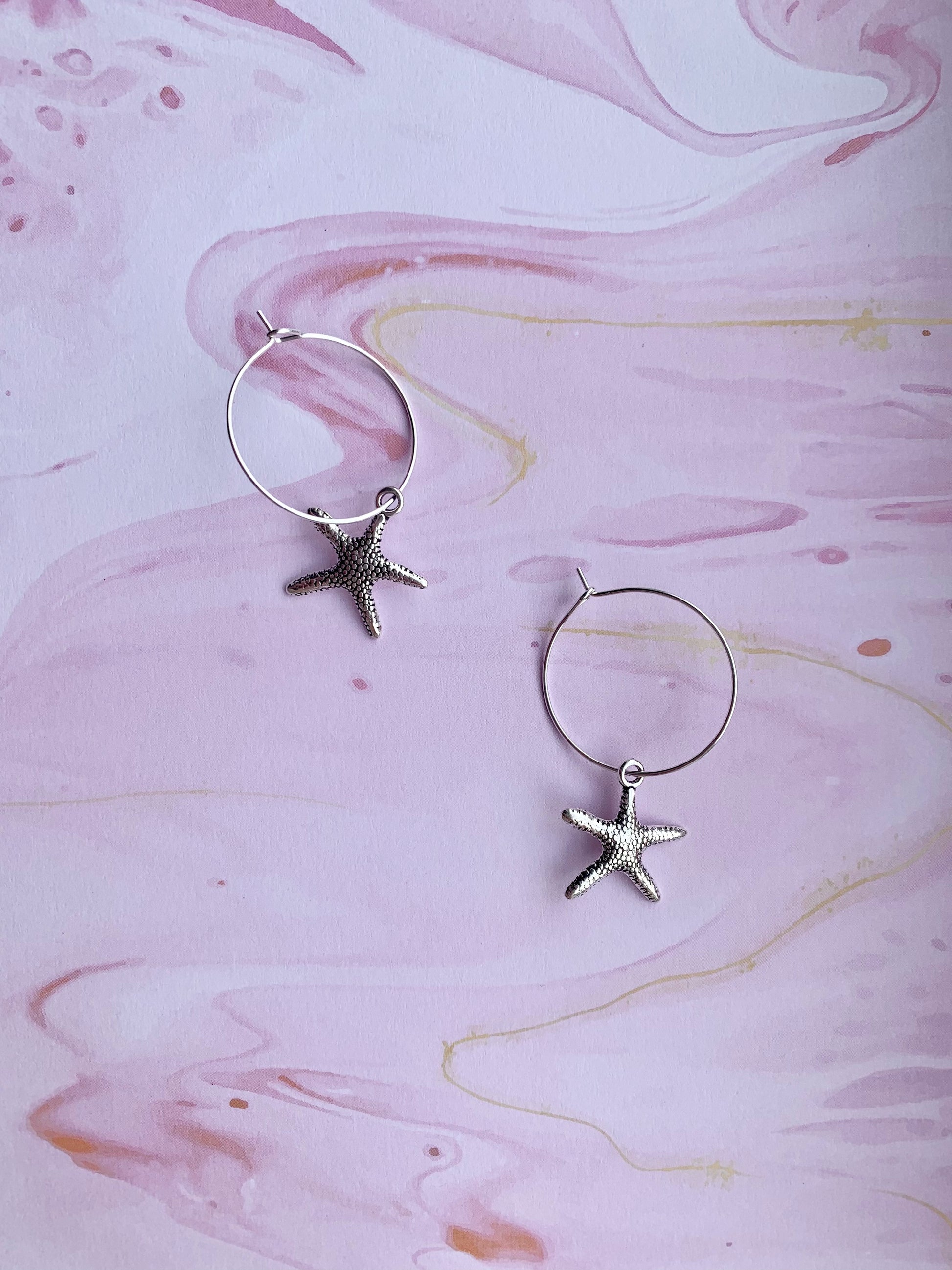 starfish earrings. mermaid earrings. alloy silver coloured charm on silver plated hoops. cute earrings. hoop earrings. 