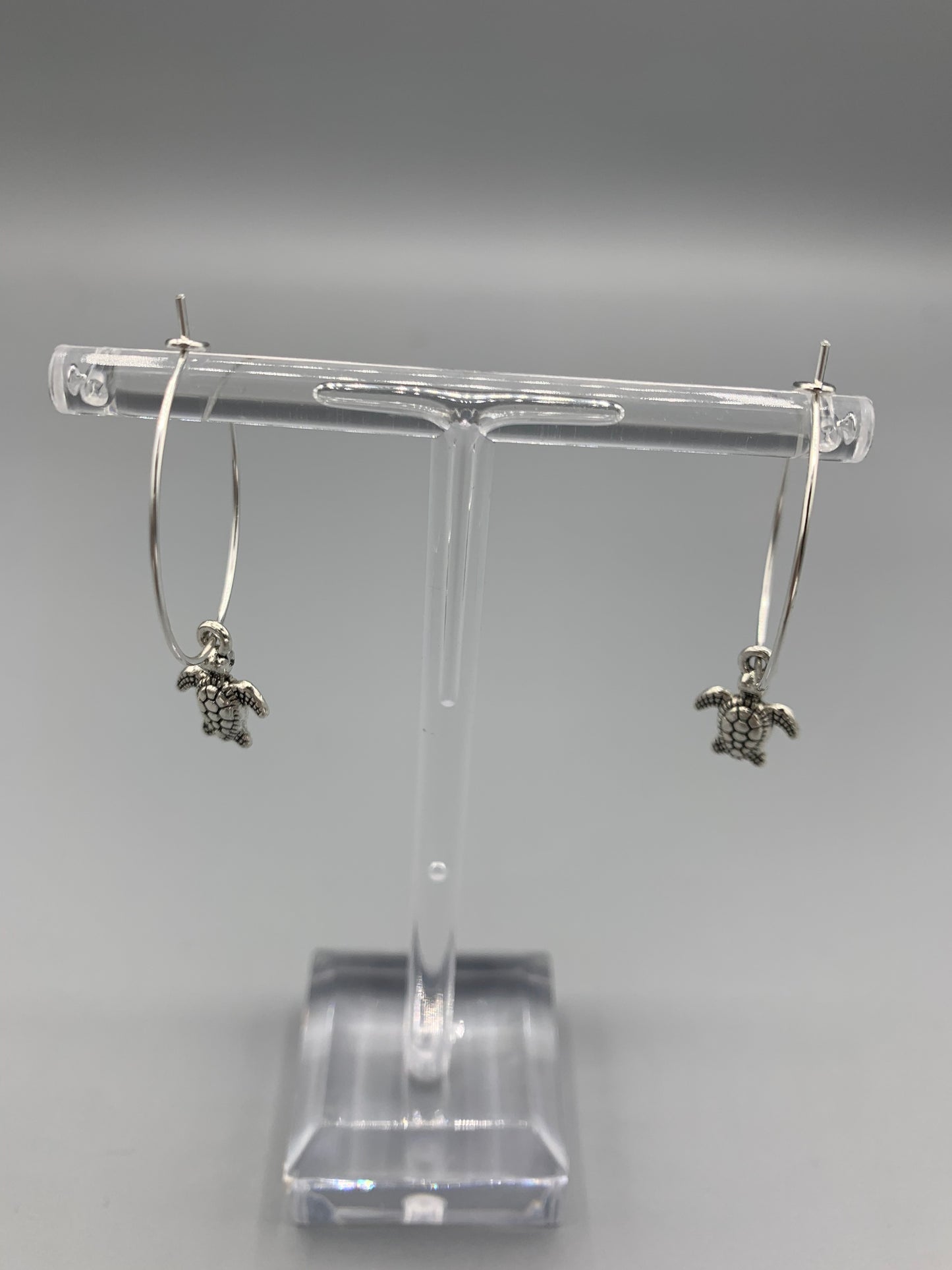 Cutest tiny turtle silver coloured alloy charm on silver plated hoops. hoop earrings. silver earrings. turtle earrings. ocean earrings. cute earrings