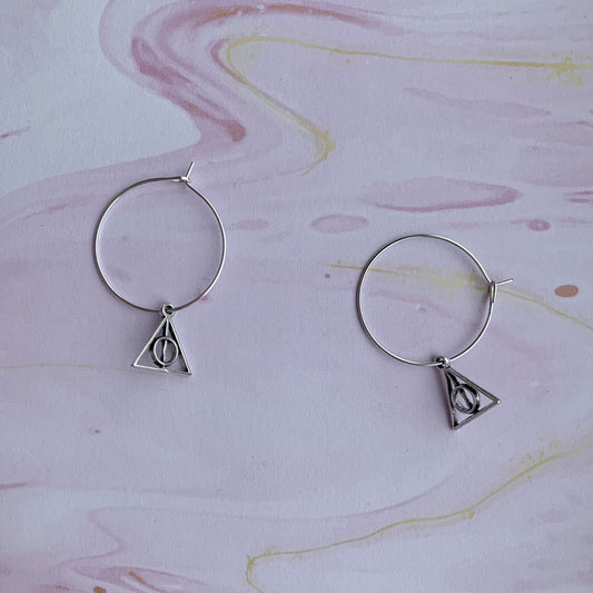 Triangle with circle and stick through the middle charms on silver plated hoops. magical earrings. harry potter earrings. cosplay earrings. 