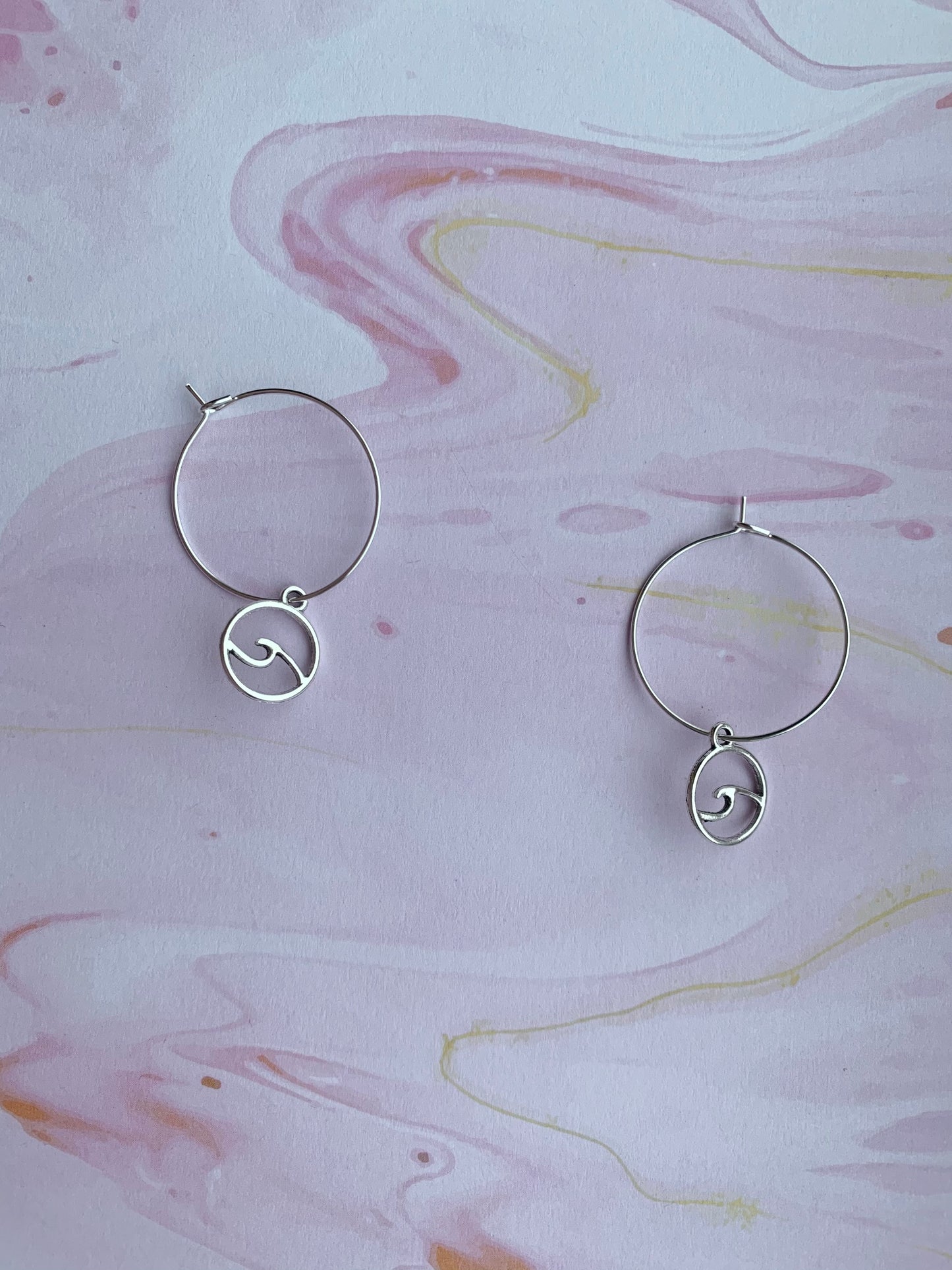 Wave earrings. alloy silver wave outline in a circle charms on silver plated hoops. hoop earrings. ocean earrings. nature earrings. sea earrings