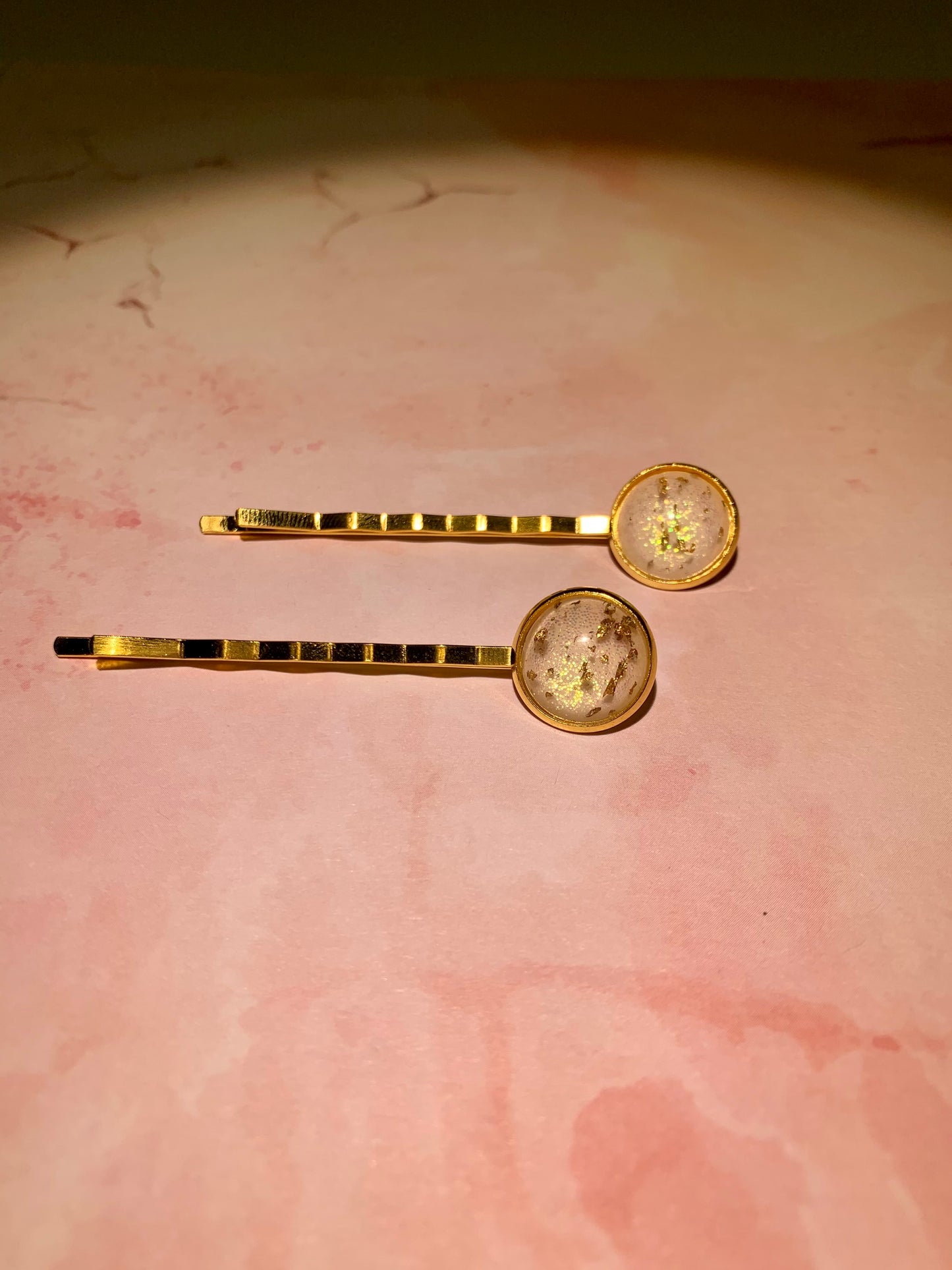 White and gold leaf hair grips